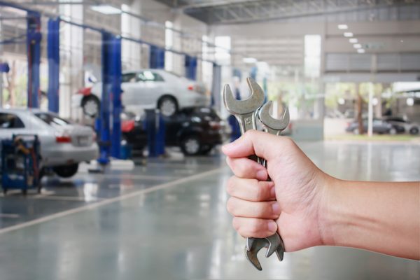 Hand of professional Auto mechanic with wrench, Auto repair service